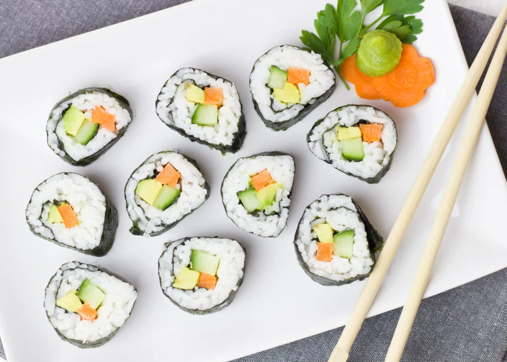 Vegan sushi with avocado and carrots on a plate